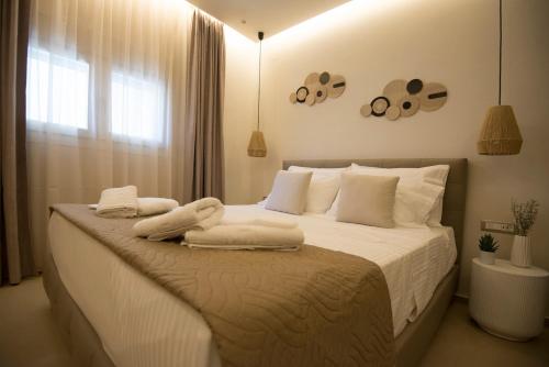 a bedroom with a bed with towels on it at Sidonia Suite in Psari Forada