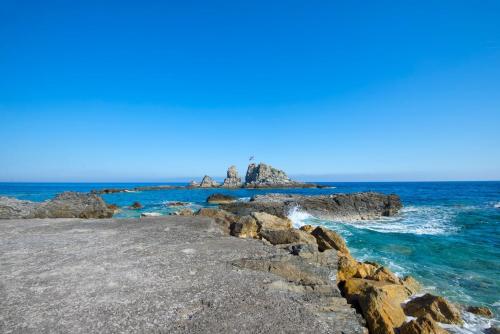 a group of rocks in the ocean near the water at Sidonia Suite in Psari Forada