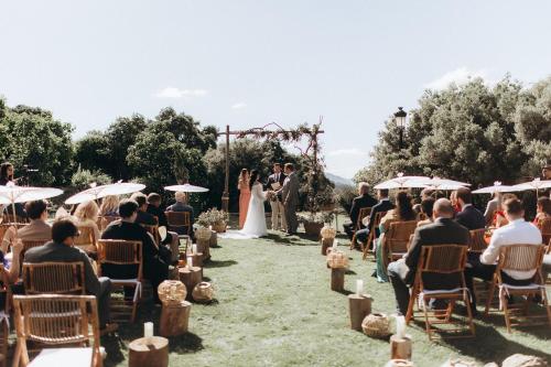 a bride and groom walking down the aisle during their wedding ceremony at Los Pilares de Ronda Boutique & Hotel in Ronda