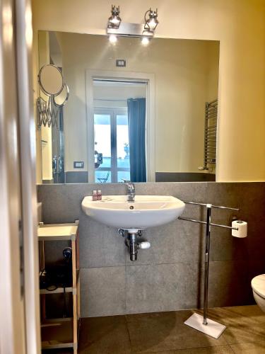 a bathroom with a sink and a large mirror at Appartamento Attico - Penthouse - Palazzo San Matteo in Palermo