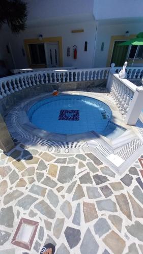 a swimming pool in a house with a stone floor at Apartments Zafiria in Ágios Konstantínos