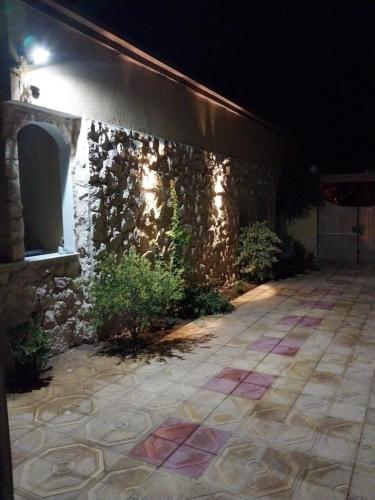 a stone building with a courtyard at night at maison les jasmins in Tazarka