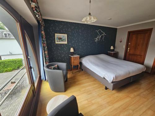 A bed or beds in a room at La Source d'Arimont