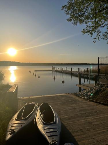 a boat parked on the shore of a lake at Chill Camp in Giewartów