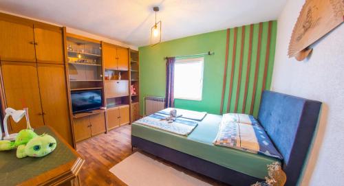 a small room with a bed and a tv at Estate - Villa Discovery in Ljubuški