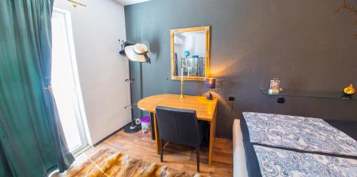 a bedroom with a desk with a mirror and a bed at Estate - Villa Discovery in Ljubuški