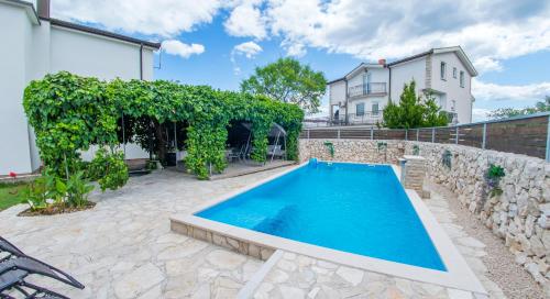 a swimming pool in a yard next to a house at Estate - Villa Discovery in Ljubuški