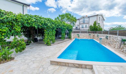 a swimming pool in a yard with a house at Estate - Villa Discovery in Ljubuški