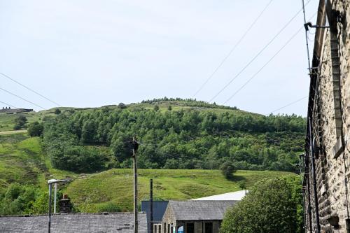 a view of a hill with a green field at Cowpe Lowe View House in Newchurch
