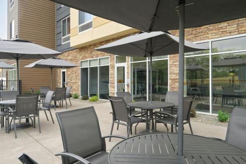 an outdoor patio with tables and chairs and umbrellas at Fairfield by Marriott Niagara Falls in Niagara Falls