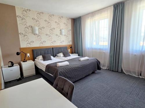 Postel nebo postele na pokoji v ubytování Hotel Orbita