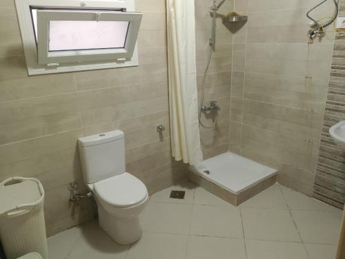 a bathroom with a toilet and a shower and a sink at Marselia beach 4 bianca 14 in Sīdī ‘Abd ar Raḩmān