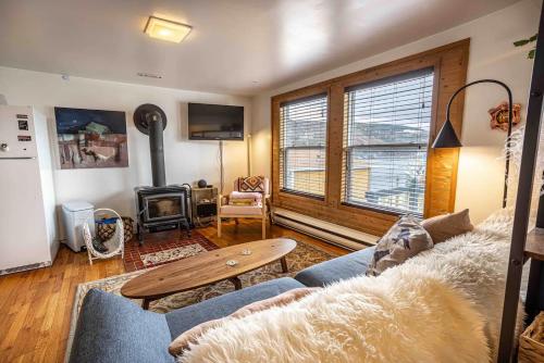 a living room with a couch and a fireplace at Iconic Battery Cottage Signal Hill Sea&City Views in St. John's