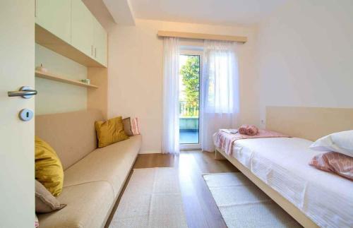 Postel nebo postele na pokoji v ubytování Apartment Malinska 34