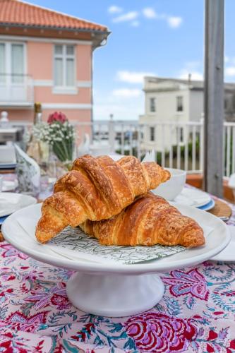 two croissants sitting on a plate on a table at Kalk Bay Condo at The Majestic in Kalk Bay