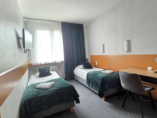 Postel nebo postele na pokoji v ubytování Hotel Orbita