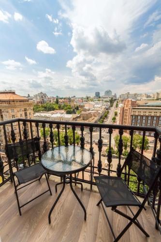 a balcony with a table and chairs and a view at Central Dayflat Apartments in Kyiv