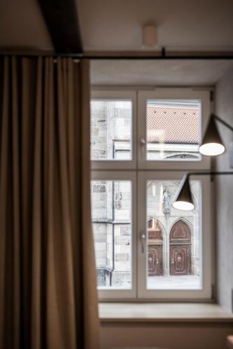 a window with a view of a building at HOTEL & SPA Goldene Rose in Dinkelsbühl