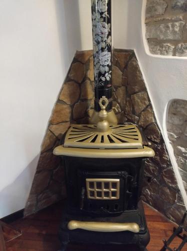 a stove in a room with a stone wall at Casa vacanze il ciclope in Erice