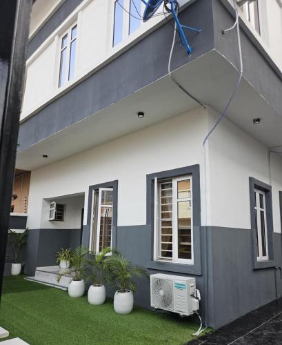 a house with plants in front of it at luxury 3bed rooms duplex lekki Lagos nigeria in Lekki