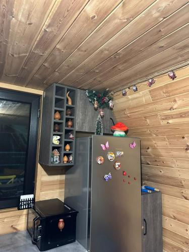 a refrigerator in a room with a wooden wall at Borjomi Story in Borjomi