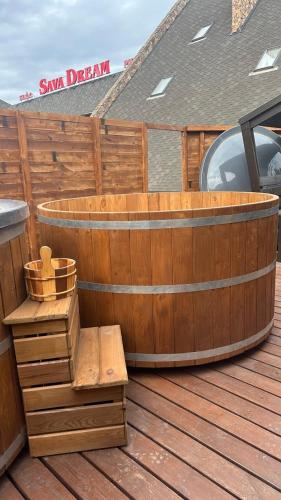 a wooden tub sitting on top of a wooden deck at Sava Dream in Zhytomyr