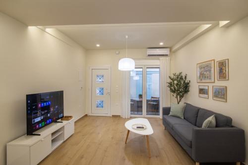 a living room with a couch and a tv at Elea in Mytilene