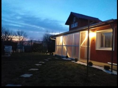 a house with a light on the side of it at Golden room in Mali Beograd