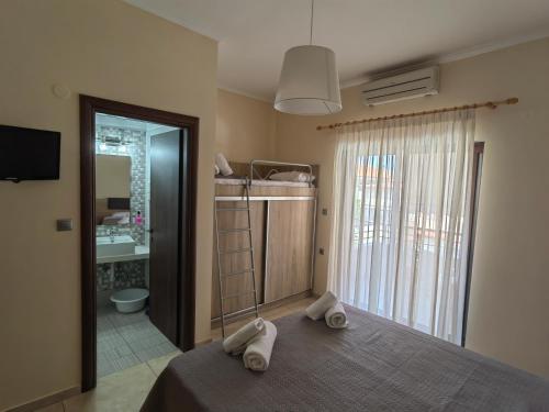 a bedroom with a bed with towels on it at Sartoupoli in Sarti