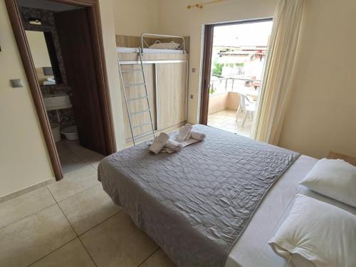 a bedroom with a bed with two towels on it at Sartoupoli in Sarti