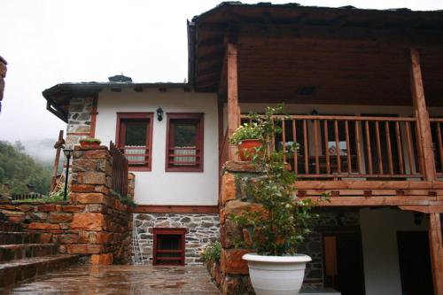 a house with a porch and a balcony at Complex Kosovo Houses in Kosovo