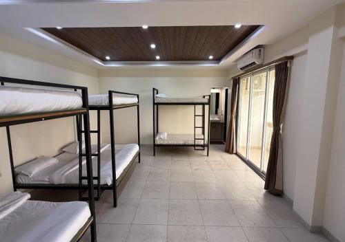 a dorm room with four bunk beds in it at Lotus Hotel & Resort in Ambernath