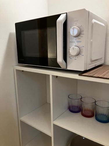 a microwave sitting on top of a shelf at Edelweiss Apartments in Villach