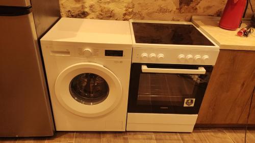 a washer and dryer in a kitchen next to a stove at Casa Stratigos in Corfu
