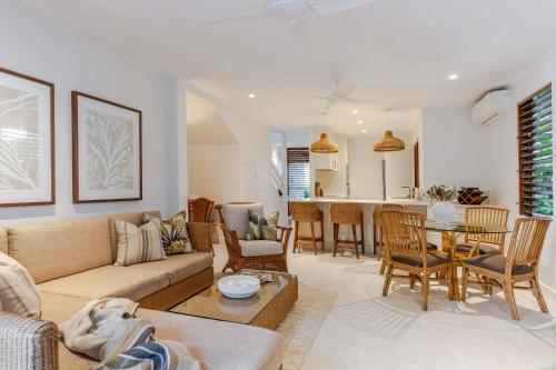 a living room with a couch and a table at Absolute beachfront, heart of Port Douglas - 24 S in Port Douglas