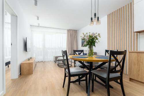 a dining room with a table and chairs at Sarbinove City Apartments in Sarbinowo