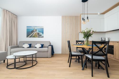 a living room with a table and a couch at Sarbinove City Apartments in Sarbinowo