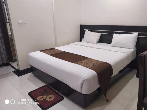 a bedroom with a large bed in a room at Hotel Elaf International in Cox's Bazar