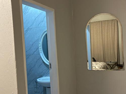 a bathroom with a sink and a mirror at The Tranquil Golden Retreat in Johannesburg