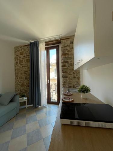 a kitchen and living room with a couch and a table at Palazzetto Longobardi in Ogliastro Cilento