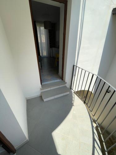 a spiral staircase in a house with a mirror at Palazzetto Longobardi in Ogliastro Cilento
