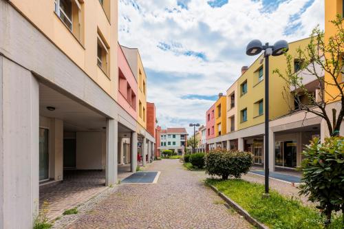 an empty street in a city with buildings at BGY Colorful Home in Grassobbio