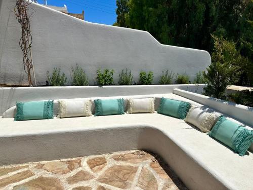 a stone bench with pillows on it at Alemarni Syros in Ermoupoli