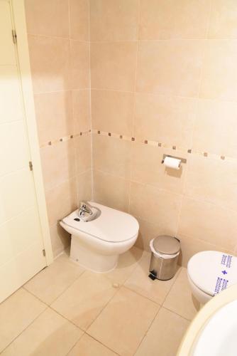 a bathroom with a toilet and a sink at Cozy apartment to enjoy all year round in Latas