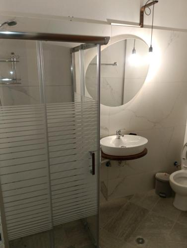 a bathroom with a glass shower and a sink at Helene Mirteni in Ialysos