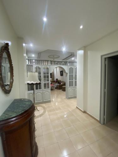 a large room with a mirror and a living room at Appartement Najma in Tangier