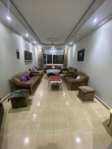 a large living room with couches and tables at Appartement Najma in Tangier