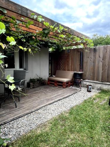 a patio with a bench on a wooden deck at Privat VCELKA in Liptovský Ján