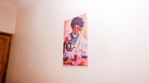 a painting of a pope hanging on a wall at Les Jardins d Amizmiz 6 piscines in Marrakech