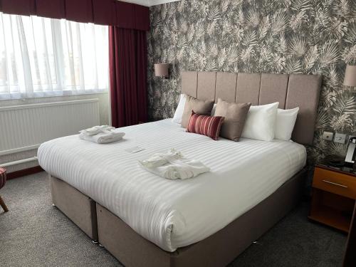 a bedroom with a large bed with two towels on it at The Liner at Liverpool in Liverpool